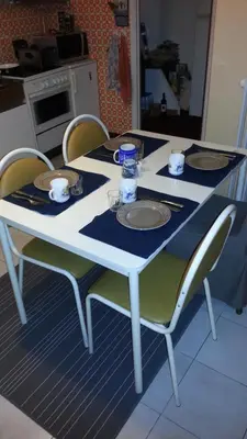 a white table with chairs and plates on it at The best known village of Belgium in Puurs