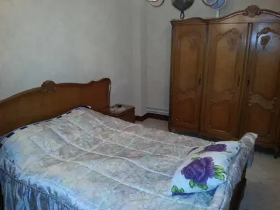 a bedroom with a bed and a wooden cabinet at The best known village of Belgium in Puurs