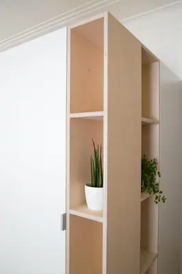 a cupboard with a potted plant in it at PM87- Modern stylish home in Antwerp