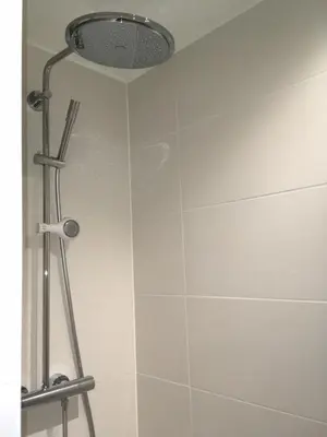 a shower with a shower head in a bathroom at PM87- Modern stylish home in Antwerp