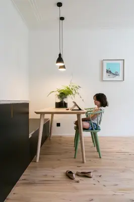 a girl sitting at a desk with a laptop at PM87- Modern stylish home in Antwerp