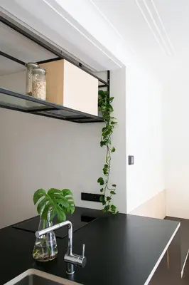 a kitchen with a black counter and a sink at PM87- Modern stylish home in Antwerp