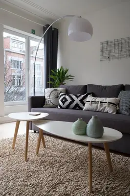 a living room with a couch and a table at PM87- Modern stylish home in Antwerp