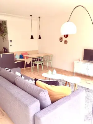 a living room with a couch and a table at PM87- Modern stylish home in Antwerp