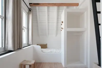 a bathtub in a room with white walls and windows at Boutique Holiday Home ZaligInAntwerpen 77 in Antwerp
