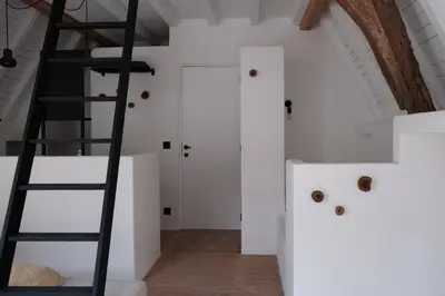 a ladder in a room with white walls at Boutique Holiday Home ZaligInAntwerpen 77 in Antwerp