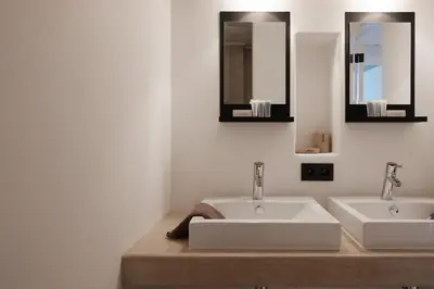 a bathroom with two sinks and two mirrors at Boutique Holiday Home ZaligInAntwerpen 77 in Antwerp