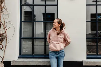 a woman standing in front of a building at Friday Gent, Exclusive Charming Guesthouse in Ghent