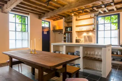a kitchen with a wooden table in a room at Friday Gent, Exclusive Charming Guesthouse in Ghent