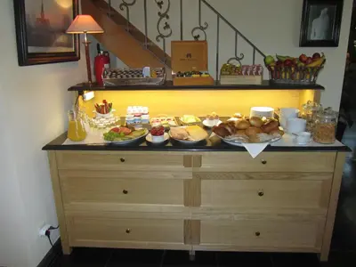 a buffet of food on top of a dresser at Hotel Klein Nederlo in Vlezenbeek