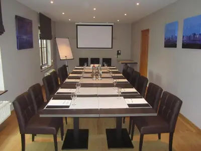 a large conference room with a long table with chairs at Hotel Klein Nederlo in Vlezenbeek