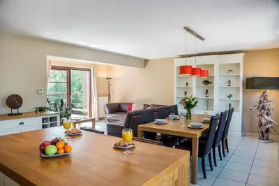 a kitchen and living room with a table and chairs at Brussels Expo Terrace Residence in Wemmel