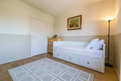 a bedroom with a white bed and a lamp at Brussels Expo Terrace Residence in Wemmel