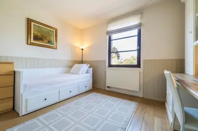 a bedroom with a white bed and a window at Brussels Expo Terrace Residence in Wemmel