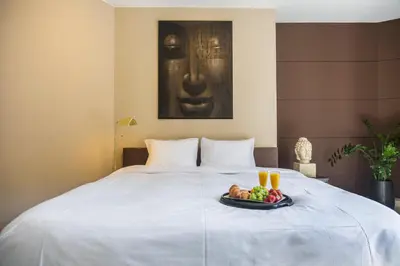 a tray of fruit and drinks on a bed at Brussels Expo Terrace Residence in Wemmel