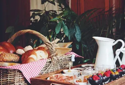 a table with a basket of bread and other foods at De Volle Maan in Sint-Lievens-Houtem
