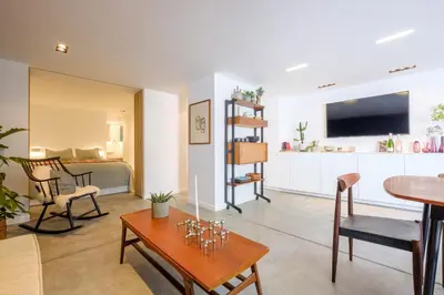 a living room with a table and a dining room at 1bd apartment with garden Brugmann area in Brussels