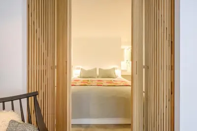 a bedroom with a bed in the corner of a room at 1bd apartment with garden Brugmann area in Brussels