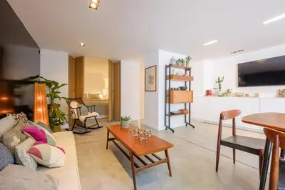 a living room with a couch and a table at 1bd apartment with garden Brugmann area in Brussels
