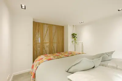 a white room with a bed and a window at 1bd apartment with garden Brugmann area in Brussels