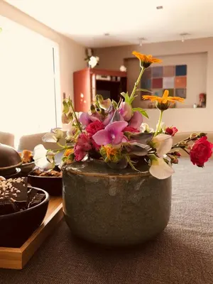 a vase with flowers in it sitting on a table at Villa Plagniau in Rixensart