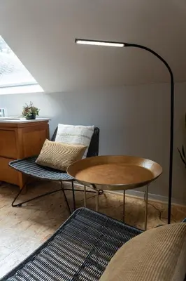 a living room with a table and a chair at Villa Plagniau in Rixensart