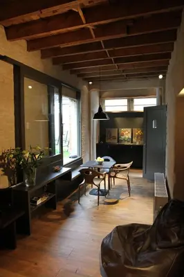 a living room with a table and chairs at Studio 17 in Ghent