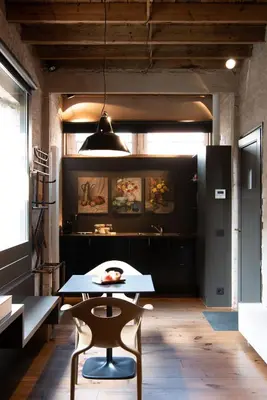 a dining room with a table and a chair at Studio 17 in Ghent