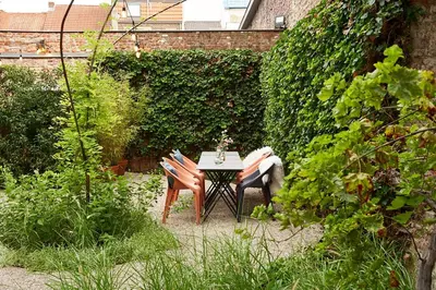 a table and chairs sitting in a garden at Studio 17 in Ghent