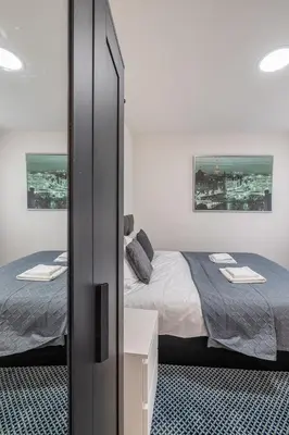 a bedroom with two beds and a mirror in it at Albert gare du Midi 31 in Brussels