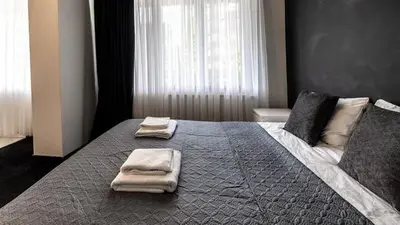 a bedroom with a large bed with two towels on it at Albert gare du Midi 31 in Brussels