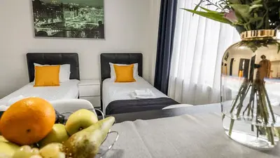 a room with two beds and a table with fruit on it at Albert gare du Midi 31 in Brussels