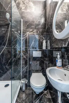 a bathroom with a toilet and a sink at Albert gare du Midi 31 in Brussels