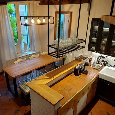 a kitchen with a counter and a table with chairs at Plezantwerpen, Huize Amoras in Antwerp