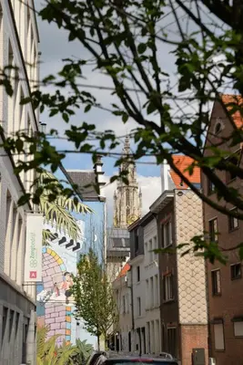 a city street with a clock tower in the distance at Plezantwerpen, Huize Amoras in Antwerp