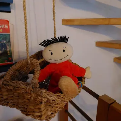 a stuffed teddy bear in a hanging basket at Plezantwerpen, Huize Amoras in Antwerp