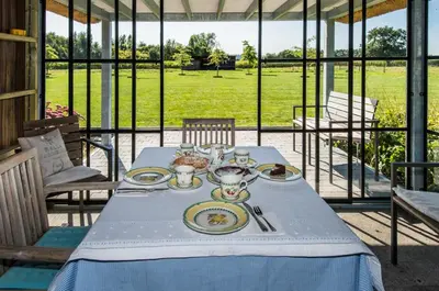 a table with plates of food on top at De Moeraseik in Zele