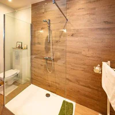 a bathroom with a shower with a glass door at De Moeraseik in Zele