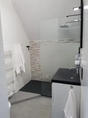 a white bathroom with a sink and a shower at Lovely Guesthouse Lier in Lint