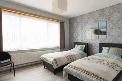 a bedroom with two beds and a window at Lovely Guesthouse Lier in Lint