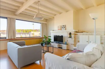 a living room with two white couches and a tv at Appartement224 in Grimbergen