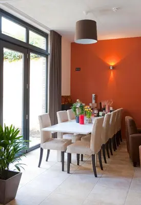 a dining room with a white table and chairs at Leuven City Hostel in Leuven