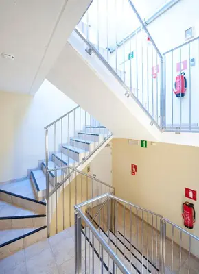a staircase in a building with a fire station at Leuven City Hostel in Leuven