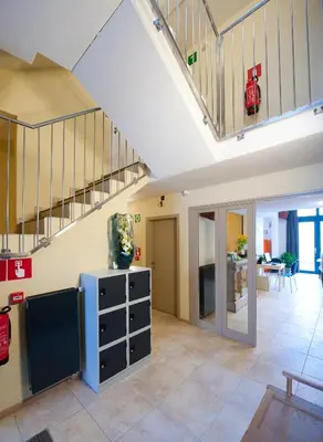 a living room with a staircase and a living room at Leuven City Hostel in Leuven