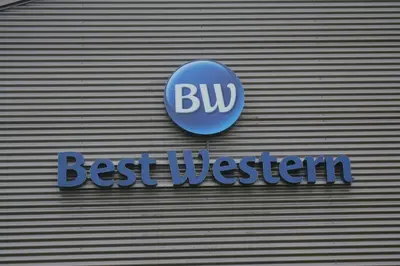 a blue sign on the side of a building at BEST WESTERN Hotel Brussels South in Ruisbroek