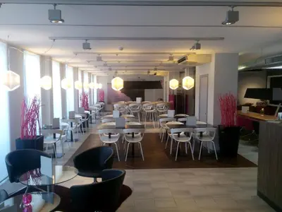 a restaurant with tables and chairs in a room at BEST WESTERN Hotel Brussels South in Ruisbroek