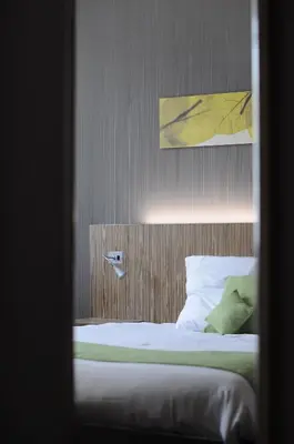 a bedroom with a bed and a painting on the wall at BEST WESTERN Hotel Brussels South in Ruisbroek