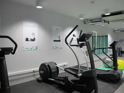 a gym with two tread machines in a room at BEST WESTERN Hotel Brussels South in Ruisbroek