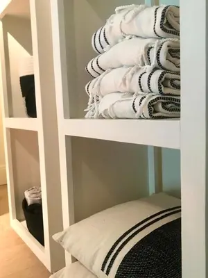 a shelf filled with towels in a bathroom at AuxiliumWellness Get Back to Serenity in Grobbendonk