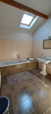 a large bathroom with a tub and a sink at B&B Euverbraeke in Beveren